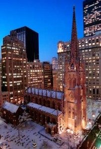 Old weathered church in the middle of modern skyscrapers