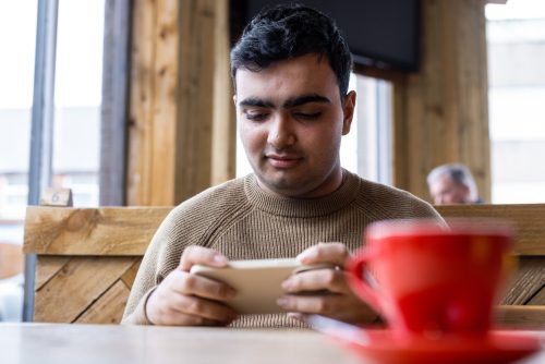 Man at cafe on phone