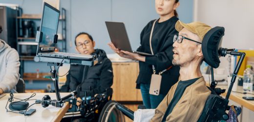 People with varying abilities working together in a small office
